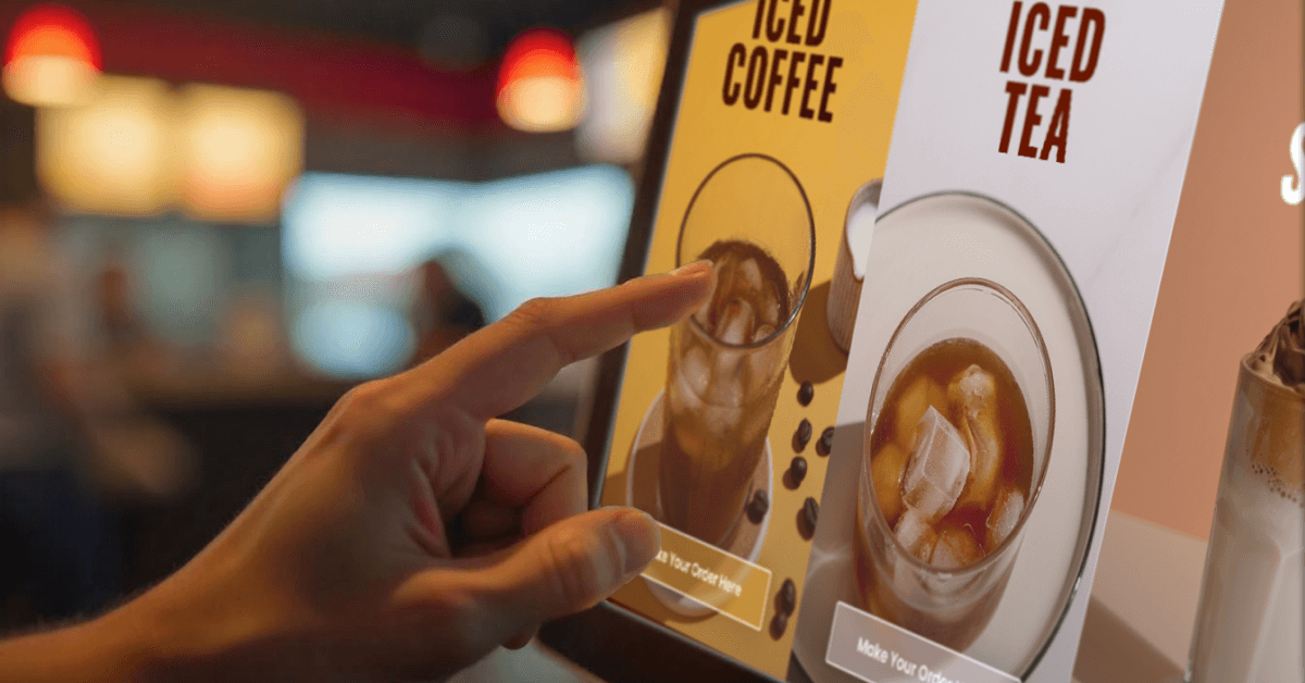 A person interacts with a digital touchscreen menu